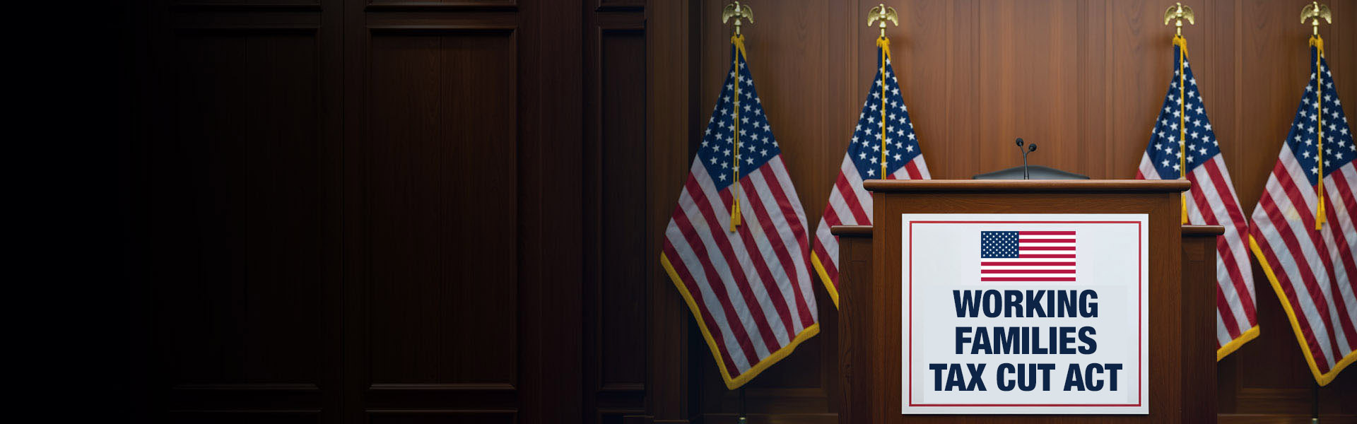 Podium with microphones in a formal room, flanked by multiple U.S. flags, displaying a sign that reads “Working Families Tax Cut Act.”